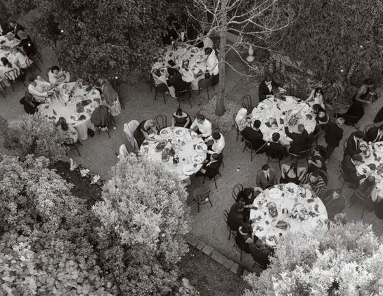 Guests gathered around tables at a garden reception