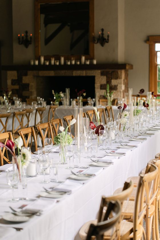 A long reception table set with candles and flowers