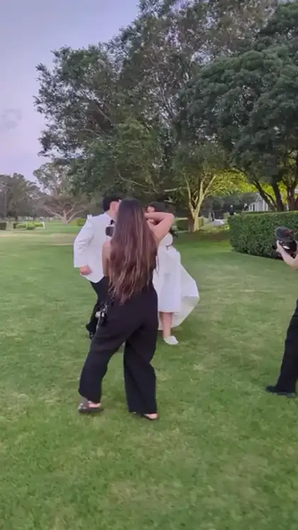 Photographing the two of them on the grass