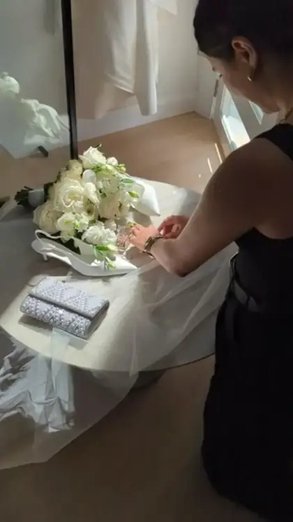 Steaming the dress before she gets in it
